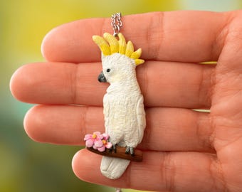 Cockatoo parrot pendant with flower, Handmade parrot figurine made of polymer clay, Exotic bird necklace, Jewelry gift for bird enthusiasts