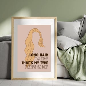 May include: A printable wall art design with a pink background and a brown outline of a woman with long hair. The text reads "Long Hair No Bra That's My Type That's Right".