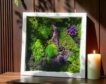Moss art in a modern white frame with vibrant green moss and purple flowers for calming eco interior design