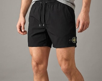 Traje de baño de verano 2026, nuevo bañador corto para hombre SI, poliéster con logo de brújula amarilla.