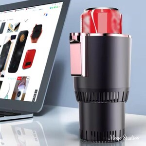 May include: A black and rose gold car cup holder with a built-in fan to keep drinks cold or warm. A can of soda is in the holder.