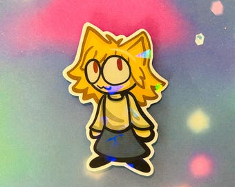 May include: A cartoon sticker of a yellow-haired character with a white shirt and blue skirt. The character has large eyes and a friendly expression.