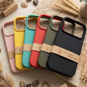 May include: A set of six smartphone cases in pink, yellow, teal, red, olive green, and black, each featuring a speckled texture and a brown paper band printed with the text From natural Wheat straw and a wheat stalk icon.