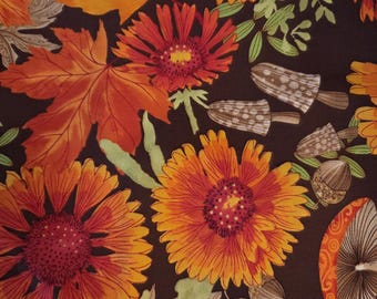 May include: A fabric with a fall-themed pattern featuring orange and yellow flowers, maple leaves, acorns, and mushrooms on a dark brown background. The design evokes a sense of autumn and nature.