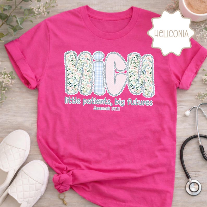 May include: A vibrant pink t-shirt with rolled sleeves. The shirt displays the word "NICU" in a floral and plaid pattern, accompanied by the text "little patients, big futures" and the Bible verse Jeremiah 29:11.