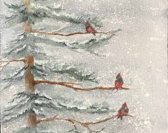 Fine Art Watercolor Image with Cardinals on Pine Tree Branches On A Snowy Blizzard,Frigid, Cold Winter Day by Janet Dosenberry
