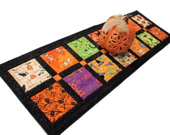 Halloween Charms Quilted Table Runner, Black and Orange Handmade Patchwork Quilt with Skeletons, Bats, Spiders