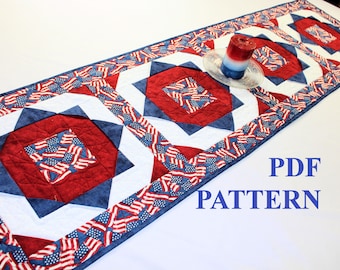 May include: A red, white, and blue quilted table runner with a starburst pattern. The runner has a border of American flags. The text "PDF PATTERN" is visible in the lower right corner of the image.