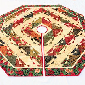 May include: An octagonal Christmas tree skirt featuring a geometric patchwork design in cream, red, dark green, and black. The border displays a floral pattern with red poinsettias and roses, finished with a red fabric trim and a center opening.