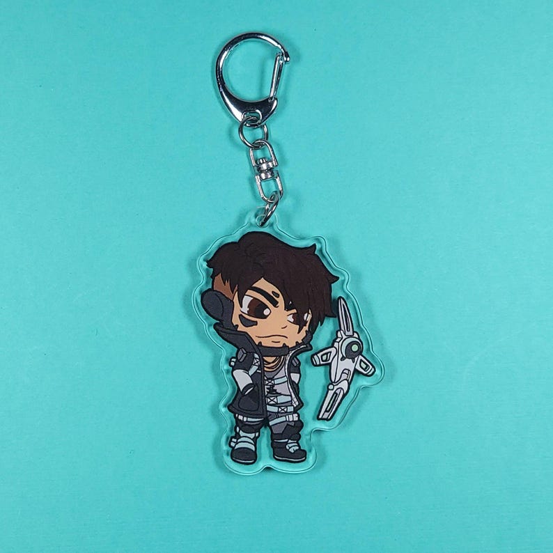 May include: A cartoon character keychain featuring a character with brown hair, a black and white outfit, and a white weapon. The keychain is made of clear acrylic.