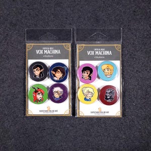 May include: Two sets of four button pins featuring characters from the Critical Role animated series Vox Machina. The pins are round and feature a cartoon style. The characters are: Percy, Vex, Vax, Keyleth, Scanlan, Pike, Grog, and Trinket. The pins are packaged in clear plastic bags with a white background and black text that reads "Critical Role Vox Machina 4 Buttons" and "Something Major Art".