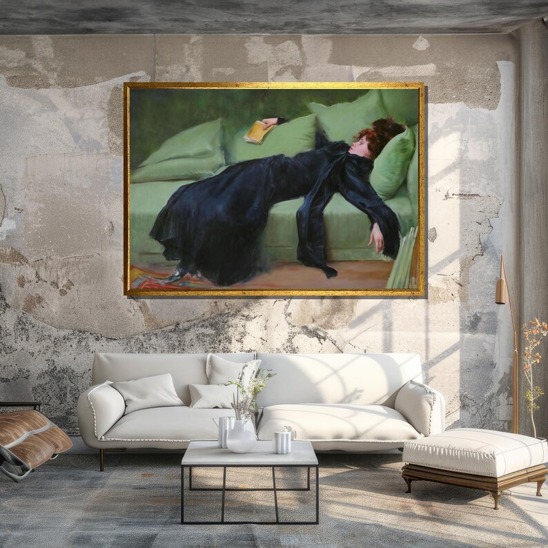 May include: A painting of a woman in a black dress lying on a green couch. The woman is holding a book in her hand and her eyes are closed. The painting is framed in gold.