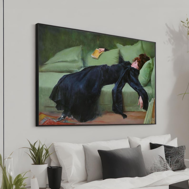 May include: A painting of a woman in a black dress lying on a green couch. She is holding a book in her hand and her eyes are closed. The painting is framed in black.