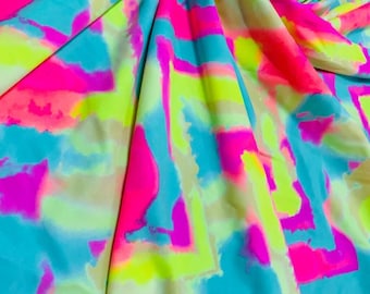 May include: A vibrant fabric with a tie-dye pattern in shades of pink, blue, green, and yellow. The fabric is soft and stretchy, making it perfect for a variety of projects.