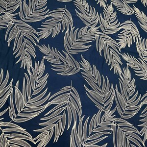 May include: Navy blue fabric with a white palm leaf pattern. The fabric is textured and has a subtle sheen.