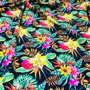 May include: A black fabric with a tropical print featuring bright yellow, pink, red, and green flowers and leaves.