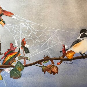 May include: Watercolor painting of a chickadee perched on a branch with autumn leaves. A delicate white spiderweb is in the background. The artwork is signed "B. Hubert" in the lower right corner. The color palette includes shades of brown, orange, green, and gray.