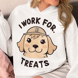 May include: White hoodie with a cartoon dog wearing a hat and the text "I work for treats".