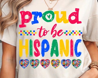 May include: A cream-colored t-shirt with the words "Proud to be Hispanic" in vibrant rainbow colors. The design includes heart shapes filled with flags and the text "Instant Download 300 DPI-PNG High Quality".