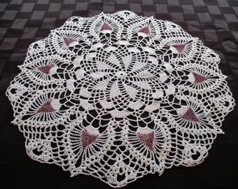 Crocheted white doily with burgundy beads