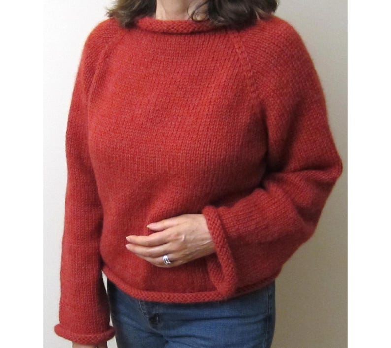 Puede incluir: Un su&eacute;ter de punto color &oacute;xido con cuello redondo y mangas largas. El su&eacute;ter tiene un dobladillo y pu&ntilde;os acanalados. Las mangas son ligeramente acampanadas. El su&eacute;ter est&aacute; hecho de un hilo suave y texturizado.