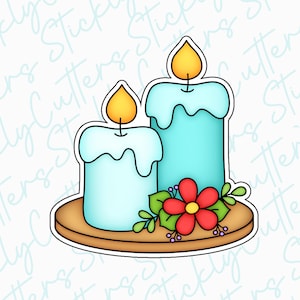 May include: Two blue candles with yellow flames on a wooden base with a red flower and green leaves.