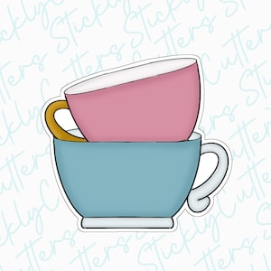 May include: Two teacups stacked on top of each other. The top cup is pink and the bottom cup is blue.