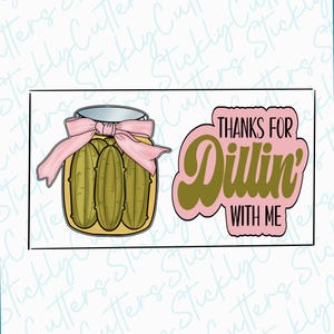 May include: A pink and green cookie cutter set featuring a jar of pickles and the text "Thanks for Dillin' with me".
