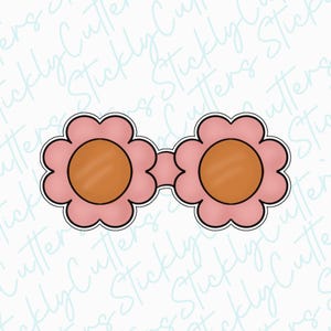 May include: A pair of pink flower-shaped sunglasses with brown lenses. The sunglasses are a cookie cutter.