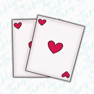 May include: Two playing cards with red hearts on a white background. The cards are stacked on top of each other.