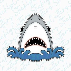 May include: A white shark cookie cutter with a toothy grin, emerging from blue waves.
