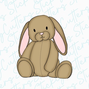 May include: A brown plush bunny rabbit with pink ears sitting with its legs crossed. The bunny has a stitched-on nose and black eyes.