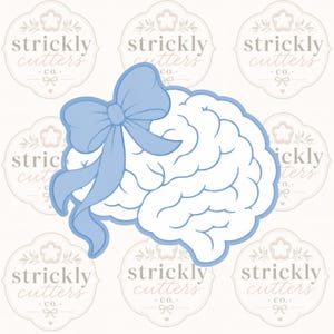 May include: A light blue cookie cutter shaped like a human brain with a large decorative bow attached to the top left side. The outline of the brain and the bow are defined by a thick light blue border, creating a distinct shape for baking.