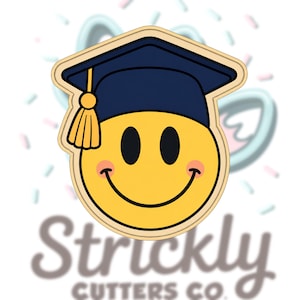 May include: A yellow smiley face cookie cutter wearing a navy blue graduation cap with a gold tassel. The cookie cutter has a light tan outline and the face has black eyes and a pink blush. The text "Struckly Cutters Co." is at the bottom.