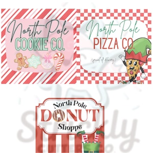 May include: Three holiday-themed signs with text. The top left sign says "North Pole Cookie Co." with cookie illustrations. The top right sign says "North Pole Pizza Co." with a pizza slice character. The bottom sign says "North Pole Donut Shoppe."
