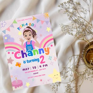 May include: A colorful birthday invitation for a girl named Channy turning two. The invitation features a cartoon girl with a rainbow and stars. The text reads "You are invited! Peek-a-Boo Channy is turning 2. May 19 | 4 PM 123 Anywhere St., Any City RSVP Lily at (123) 456-7890"