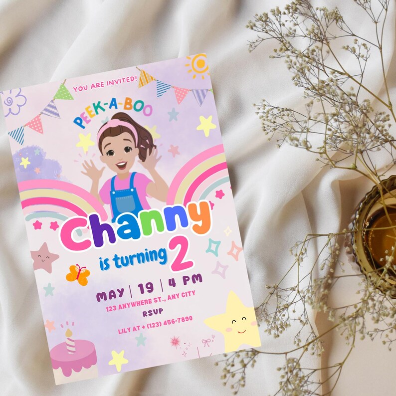 May include: A colorful birthday invitation for a girl named Channy turning two. The invitation features a cartoon girl with a rainbow and stars. The text reads "You are invited! Peek-a-Boo Channy is turning 2. May 19 | 4 PM 123 Anywhere St., Any City RSVP Lily at (123) 456-7890"