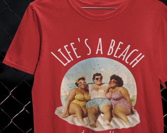 May include: Red t-shirt featuring the text "LIFE'S A BEACH" above a vintage illustration of three people in swimwear on a beach. The words "stay salty" are below the illustration.