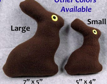 May include: Two plush brown bunny rabbits, one large and one small. The large bunny is 7 inches by 5 inches and the small bunny is 5 inches by 4 inches.  Other colors are available.