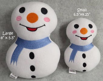 May include: Two plush snowman dog toys, one large and one small. The large snowman is 8 inches by 5.5 inches and the small snowman is 6.5 inches by 4.25 inches. Both snowmen are white with black eyes, a black mouth, an orange nose, and pink cheeks. They both have a blue scarf around their necks.