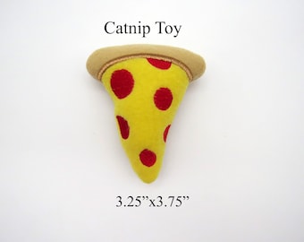May include: A yellow felt catnip toy shaped like a pizza slice with red felt pepperoni. The toy is 3.25 inches by 3.75 inches.