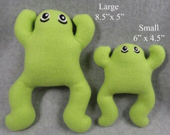 May include: Two plush green frog toys. The larger frog is 8.5 inches by 5 inches. The smaller frog is 6 inches by 4.5 inches.