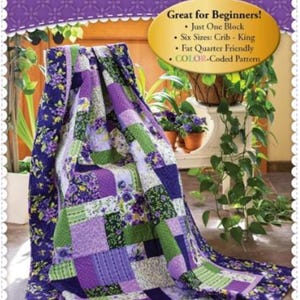 May include: A purple, green, and white quilt with a floral pattern. The quilt is folded and displayed on a table with plants in the background. The text "Easy as ABC and 123" is at the top of the image. The text "Great for Beginners!" is below the quilt. The text "Just One Block" is below the text "Great for Beginners!" The text "Six Sizes: Crib - King" is below the text "Just One Block". The text "Fat Quarter Friendly" is below the text "Six Sizes: Crib - King". The text "COLOR-Coded Pattern" is below the text "Fat Quarter Friendly". The text "ShabbyFabrics.com" is at the bottom of the image.