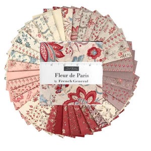 May include: A circular stack of fabric squares with floral patterns in shades of red, pink, blue, and cream. The fabric is labeled "Fleur de Paris" by French General.