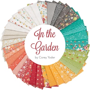 May include: A circular arrangement of fabric squares in various colors and patterns, including floral, striped, and solid designs. The text "In the Garden" by Corey Yoder is displayed in a white circle in the center of the fabric arrangement.