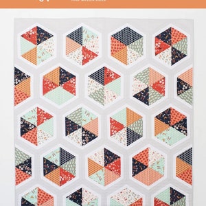 May include: A quilt pattern for a triangle hexies quilt. The pattern is for a baby, throw, twin, and queen size quilt. The quilt is made with fat quarter fabric. The quilt is made with a variety of colors and patterns. The quilt is made with a white background and has a white border.