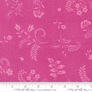 May include: Hot pink fabric with a textured vertical stripe pattern. The fabric features a repeating floral design in a lighter shade of pink. The design includes flowers, leaves, and swirling vines. The fabric is marked with a ruler in inches.