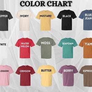 May include: A colour chart showing t-shirts in a range of hues: pepper, ivory, mustard, black, and blue jean. Other colours include white, watermelon, moss, seafoam, and yam. The chart also shows blossom, crimson, butter, berry, and espresso.