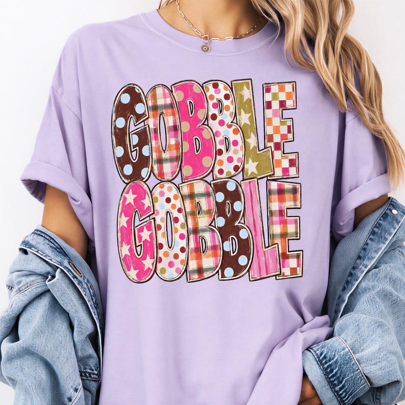 A person wearing a purple t-shirt with the text "GOBBLE GOBBLE" printed on it.