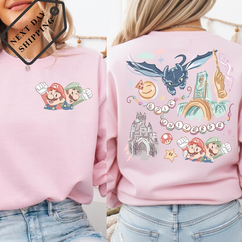 a woman wearing a pink sweatshirt with a colorful and whimsical design on the back.